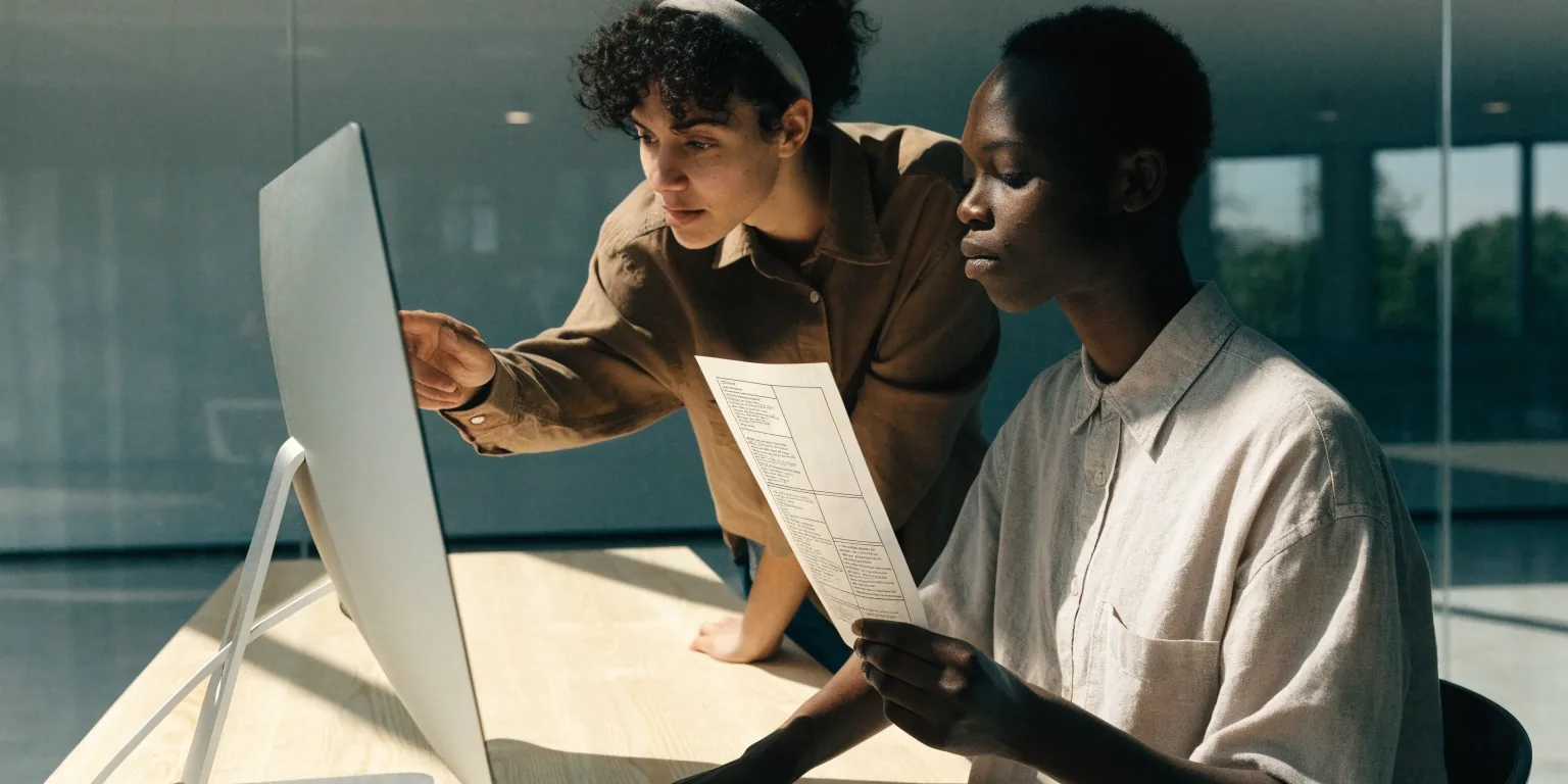 Design and copy developed side by side on a desktop monitor in a bright studio
